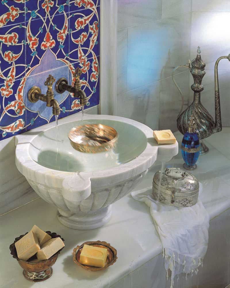 a white sink sitting on top of a counter next to a blue tile covered wall, classique, zellige