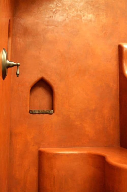 an orange wall with a door and window in the corner, next to some steps, classique, tadelakt